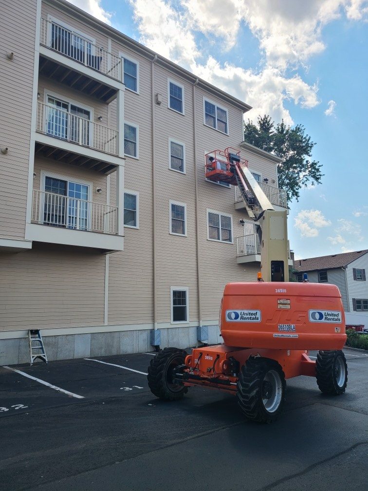 Aura Painting commercial job Boston MA — boom lift apartment building exterior